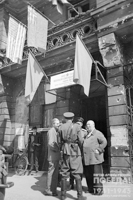 German residents talk to the Military Commandant of the 3rd section of the Mitte District, Captain V. Shorin, at the entrance to the commandant's office