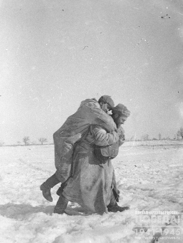 Combat medic foreman S.Pivovarov carrying a wounded soldier off the battlefield