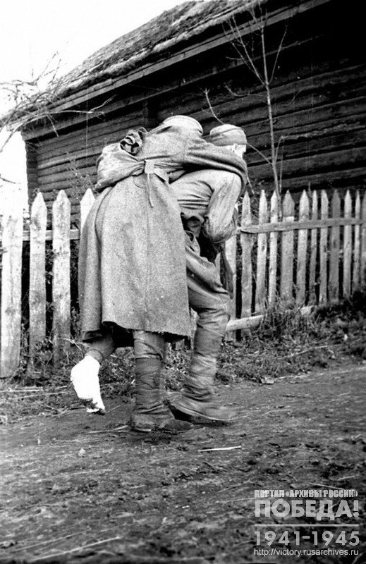 Combat medic evacuating a wounded soldier from a mobile hospital to a field hospital