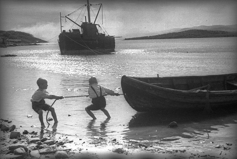 Young boys pulling a boat