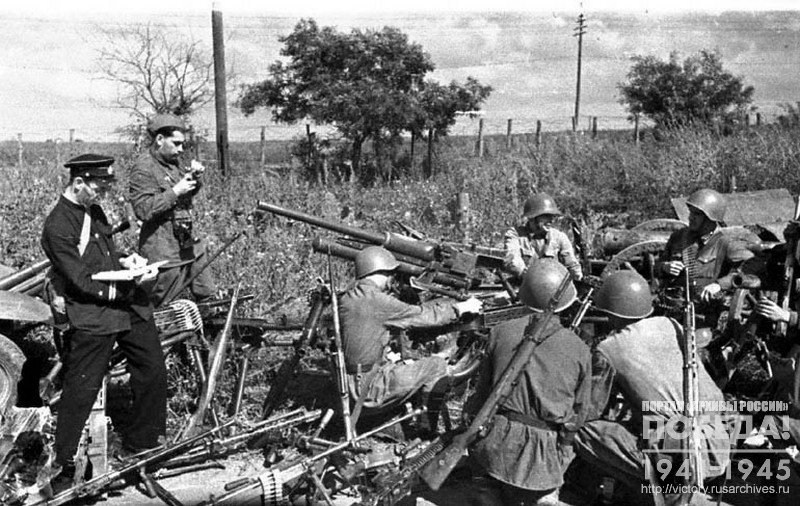 Soldiers participating in the defense of Odessa, at the captured enemy weapons. Left: artist L. Sayfertis and photojournalist of the newspaper “Krasnaya Zvezda” Khalip Y.