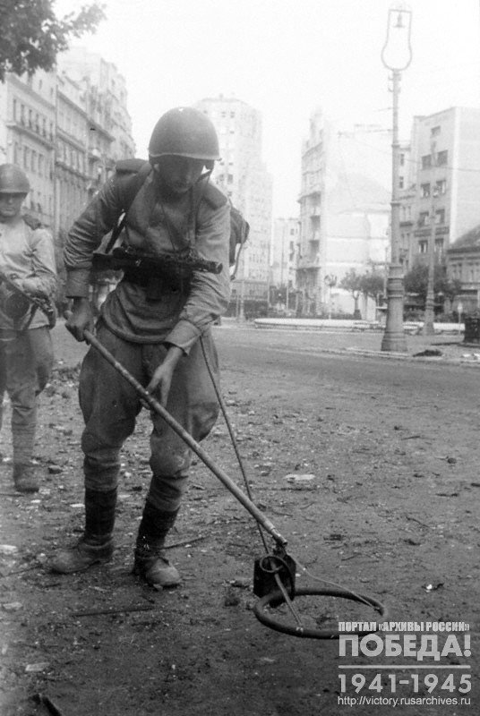 Soviet bomb disposal specialists with mine detectors in the streets of Belgrade