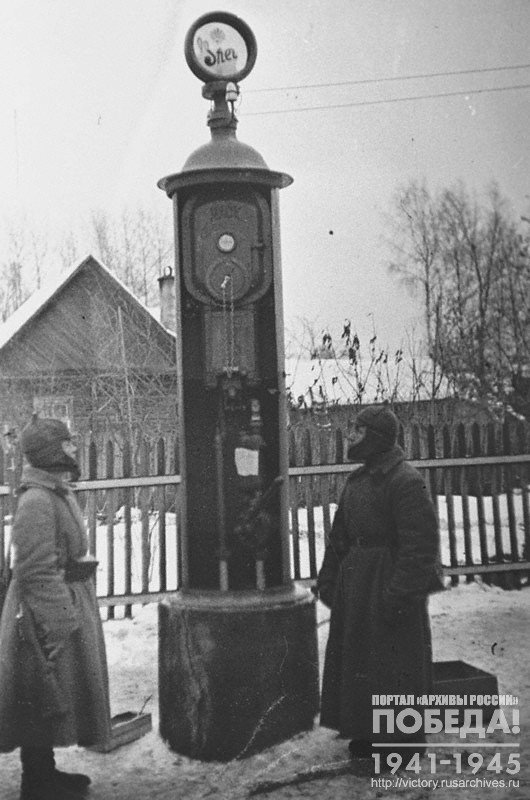 Red Army soldiers guard a gasoline pump in the town of Raivola