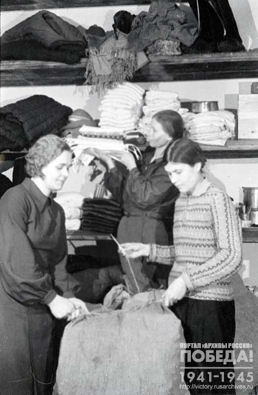 Housewives, residents of the Stalin District of Grozny pack things collected as gifts to the front-line soldiers